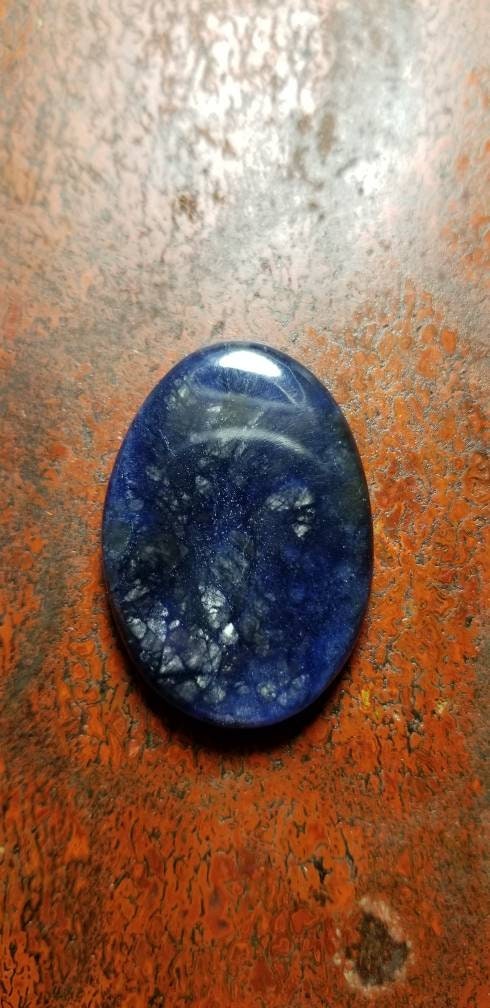 38.8ct chatoyant sodalite oval cabochon