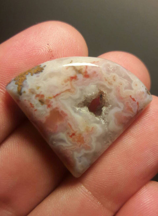 Freeform pink moss agate cabachon.