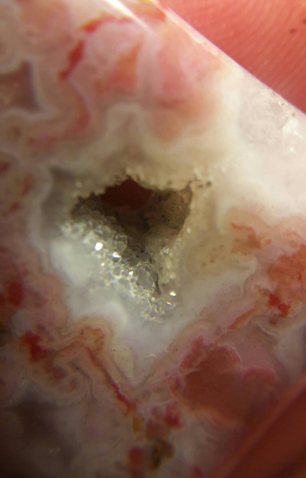 Freeform pink moss agate cabachon.