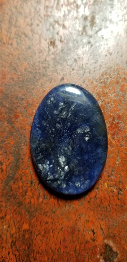 38.8ct chatoyant sodalite oval cabochon