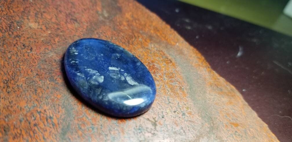 38.8ct chatoyant sodalite oval cabochon
