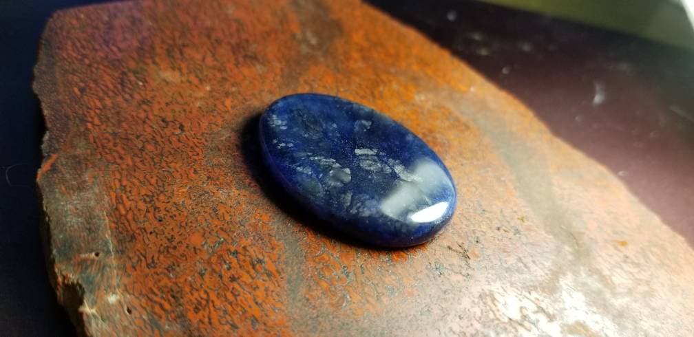 38.8ct chatoyant sodalite oval cabochon