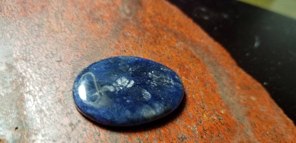 38.8ct chatoyant sodalite oval cabochon